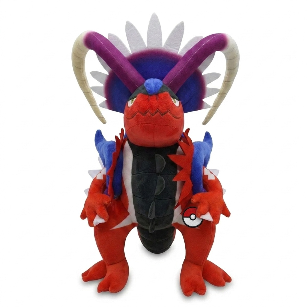Peluche Koraidon con distintivo che prova l'autenticità del prodotto.